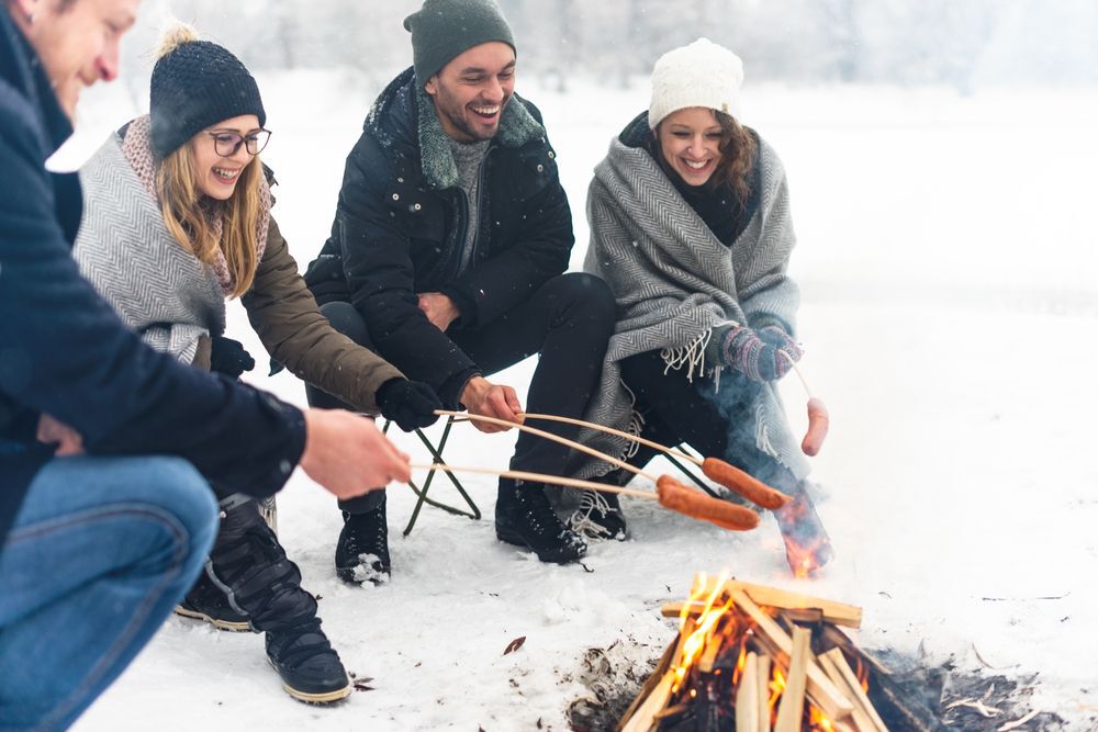 People gathered around a campfire in the snow