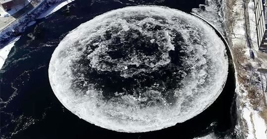 a huge spinning ice disc in the freezing waters of the Presumpscot River in Westbrook, Maine.