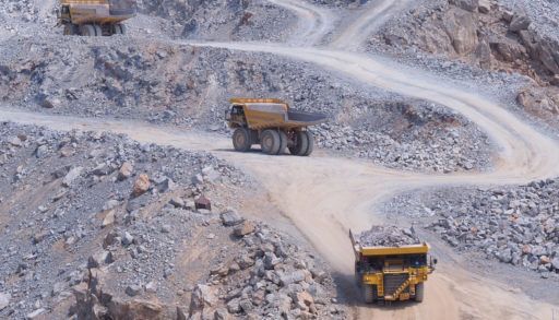 Dump trucks driving in a limestone gravel quarry