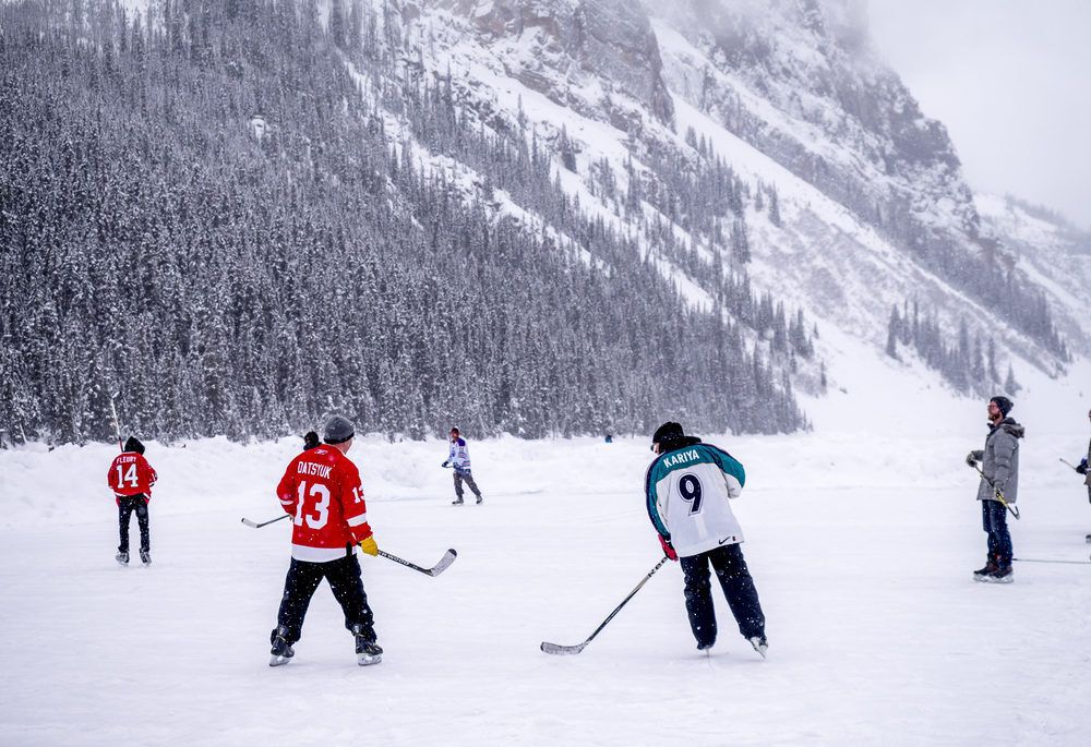 people-playing-ice-hockey-on-lake-in-lake-louise-banff