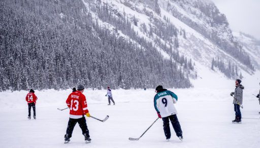 people-playing-ice-hockey-on-lake-in-lake-louise-banff