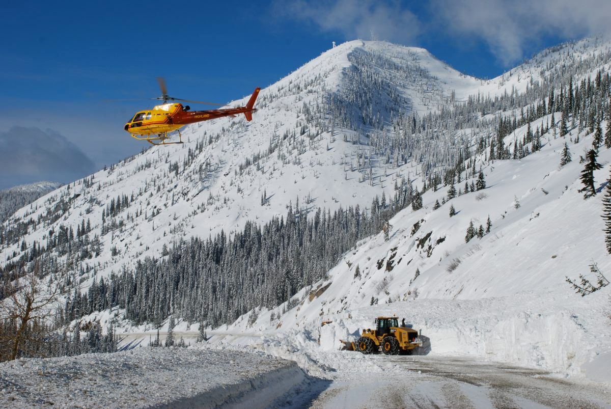helicopter-flying-over-closed-mountain-road-due-to-avalanche-closure