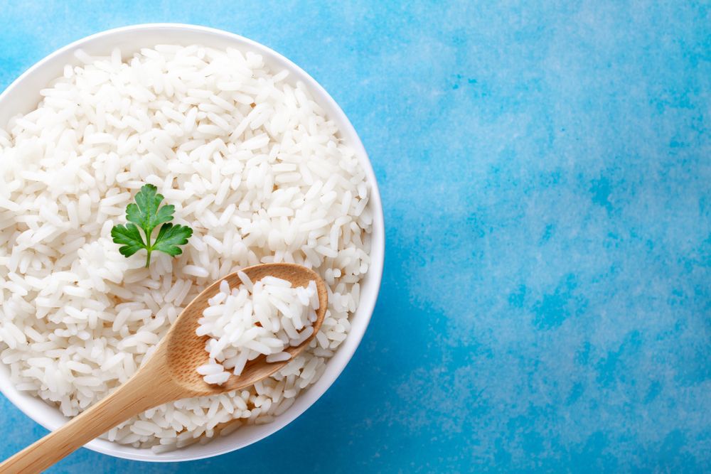 A-dish-of-white-rice-against-a-blue-background