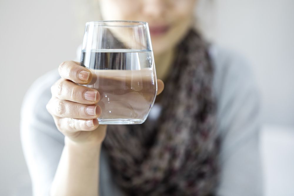 a-young-woman-holding-a-glass-of-water