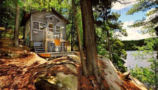 A cottage on an island by the water.