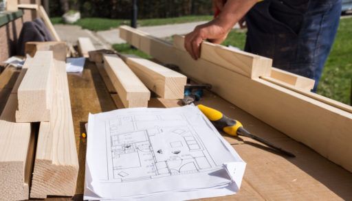 a-carpenter-at-work-outside-with-plans