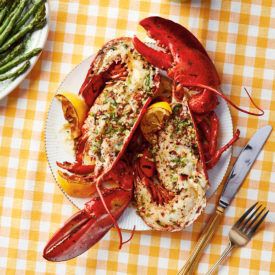 Wood-grilled lobster served on a plate on a yellow checkered table