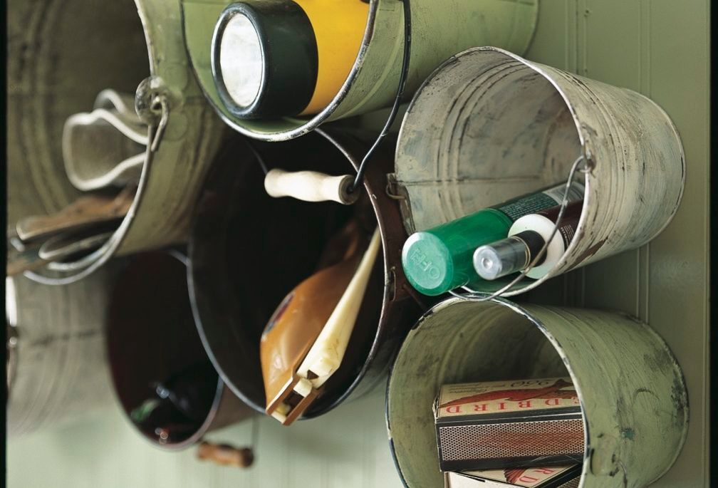 Rustic buckets on wall holding items