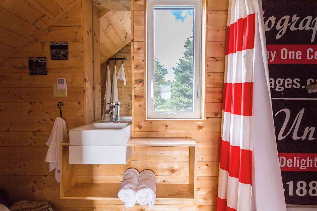 Interior view of bathroom sink, shower curtain and window