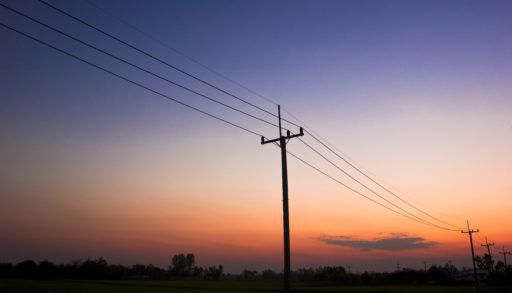 Silhouette of hydro poles at sunset