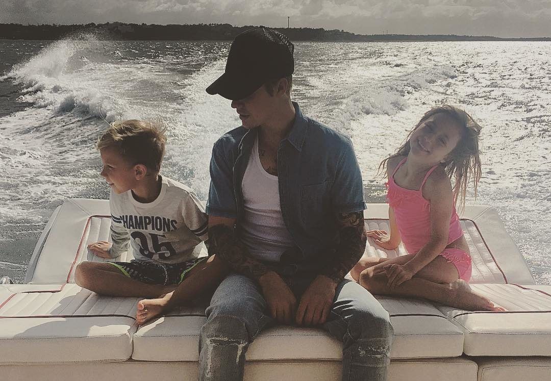 Justin Bieber with younger brother and sister on a boat ride