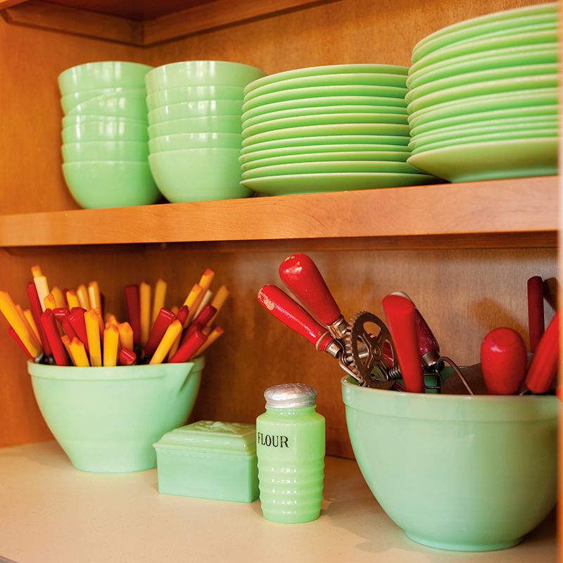 jadeite bowls and plates sitting on shelves