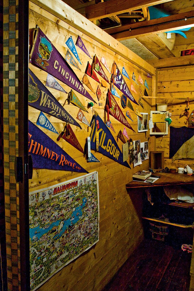 camp pennants hanging on a wood panel wall