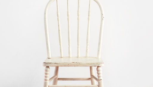 white vintage chair on striped rug