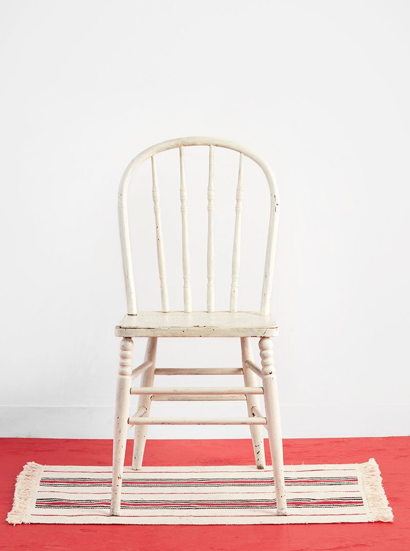 white vintage chair on striped rug