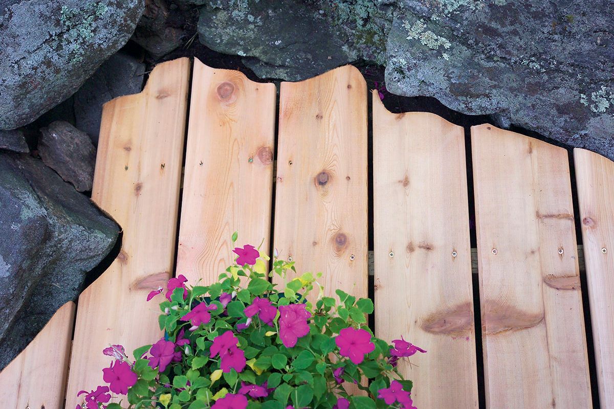custom-scribed deck boards around a rock formation