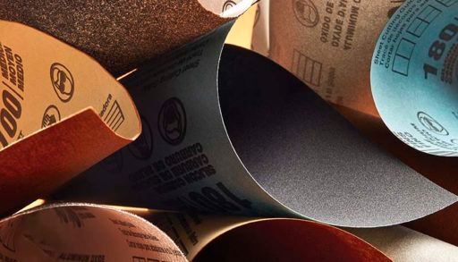 various types of sandpaper on orange background