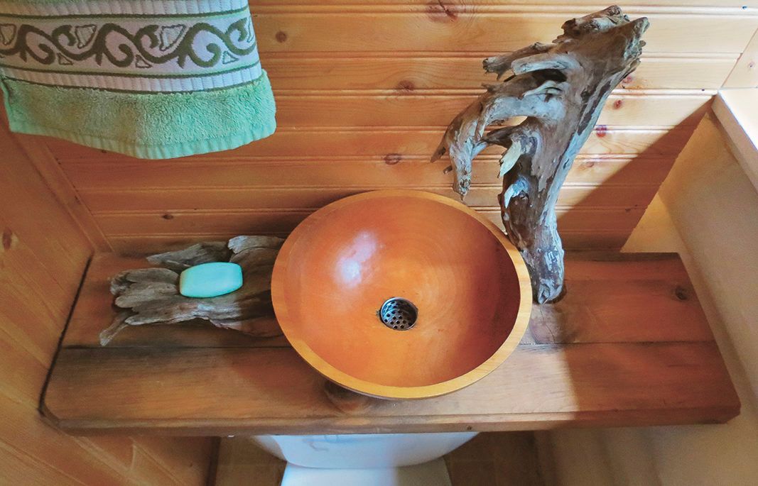 wooden salad bowl turned into a sink and a toilet