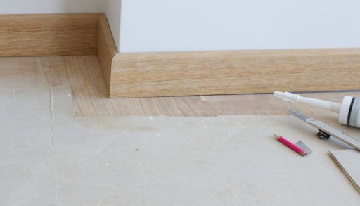 wooden baseboards installation closeup