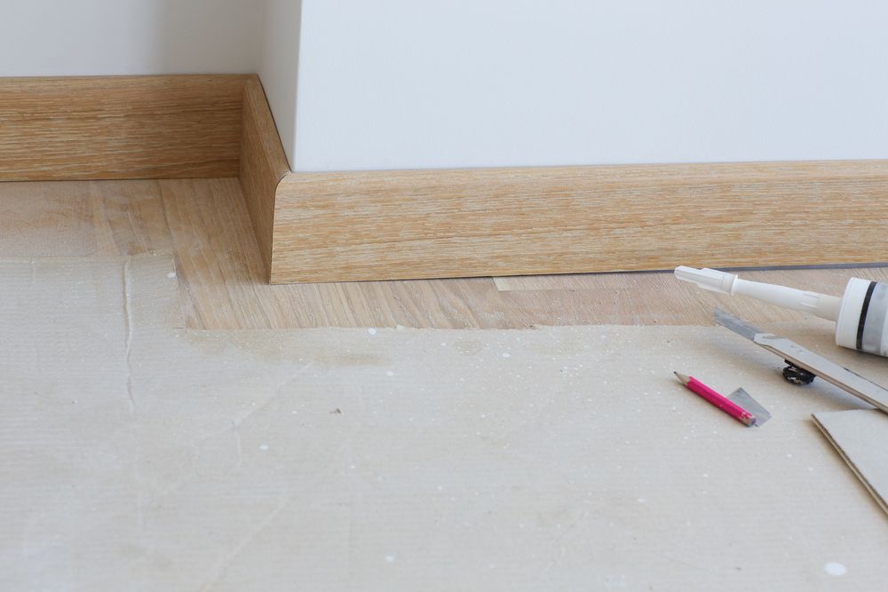 wooden baseboards installation closeup