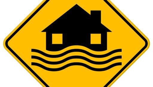 Flood Disaster Yellow Sign - House and waves on yellow sign isolated on white background