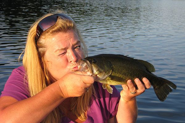 woman kissing bass fish, love