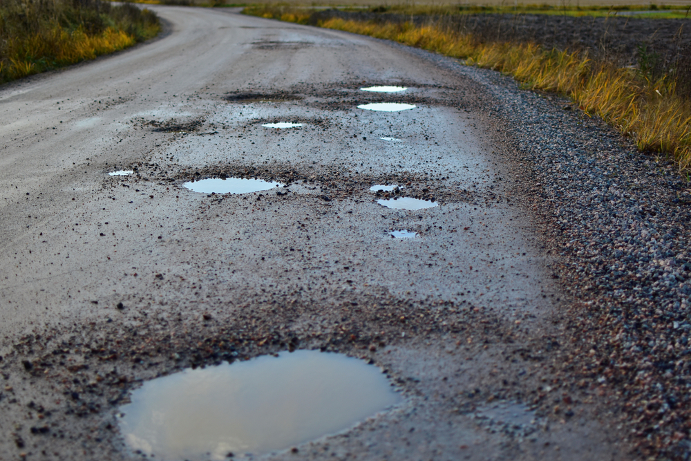 gravel road with pot holes