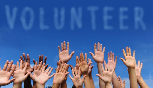 Hands raised in a show of volunteerism