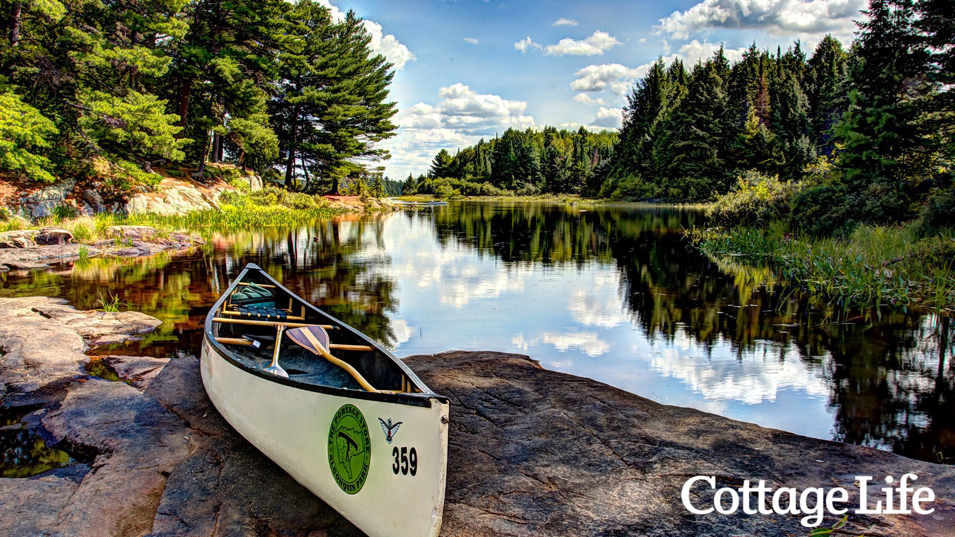 A canoe sits on the rocks