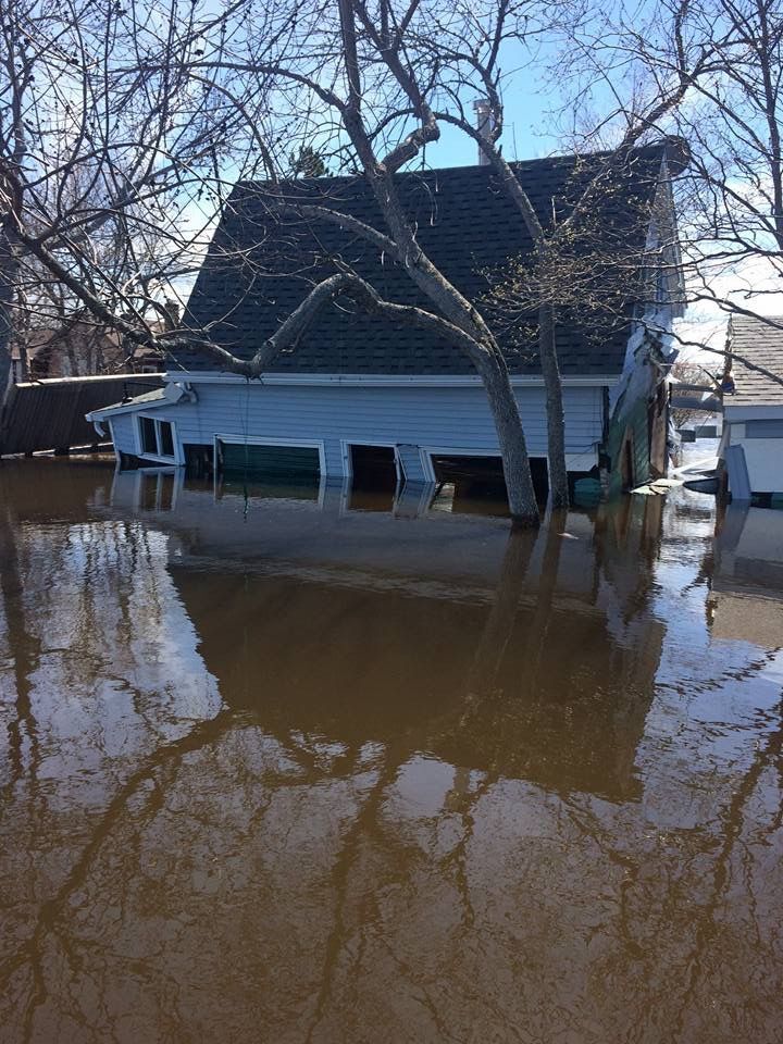 cottage partly submerged in flood