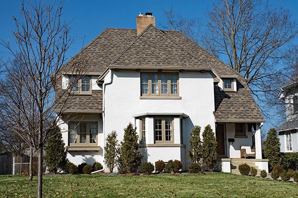 A lovely white stucco house with a hip roof.