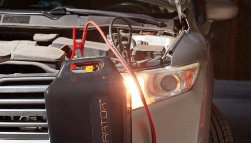 cargenerator hooked up to suv with its hood open