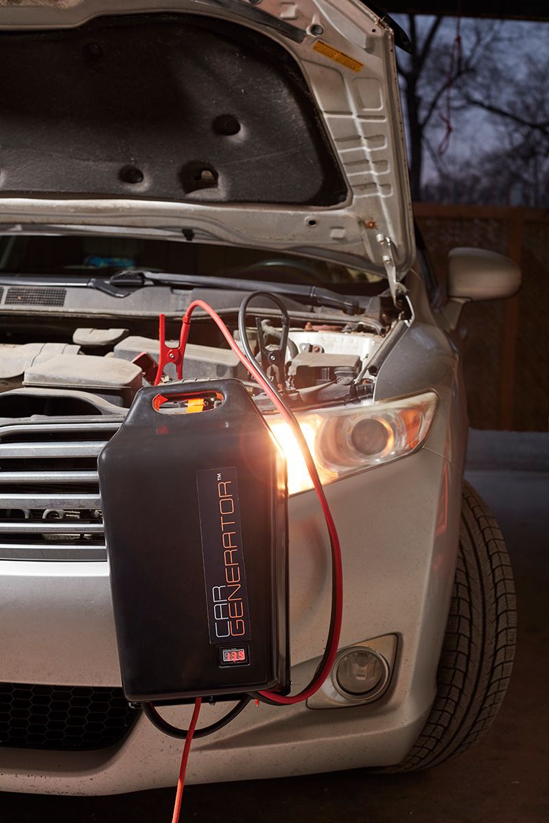 cargenerator hooked up to suv with its hood open