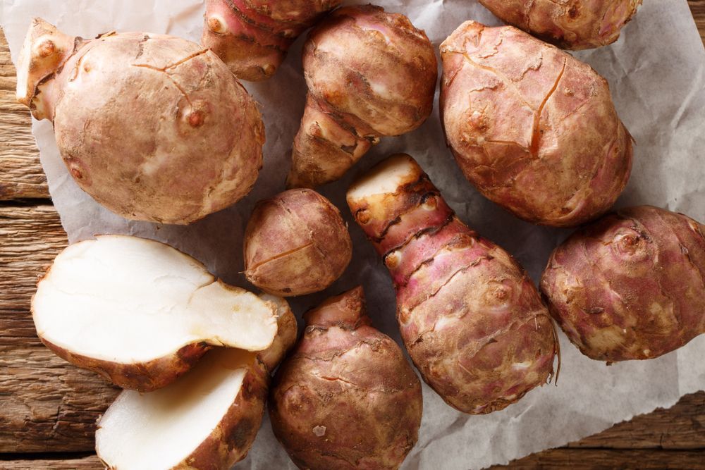Jerusalem artichoke also called sunroot, sunchokes, earth apple, or topinambour close-up on the table. horizontal top view from above
