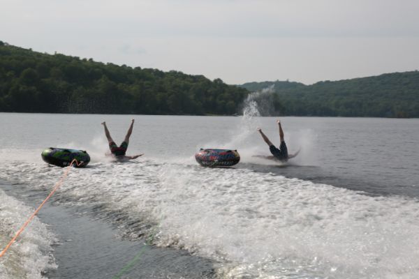 two people wiping out on tubes