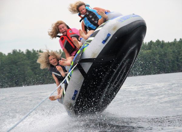 Three women airborne on a tube