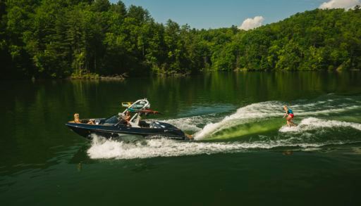 surfing behind malibu wakesetter