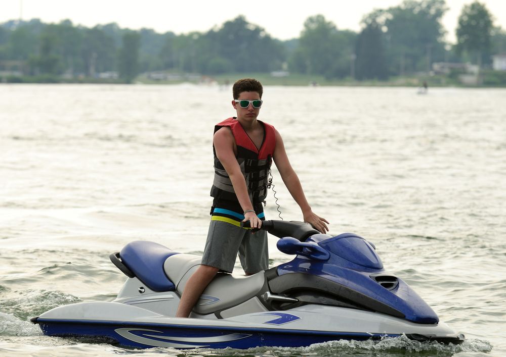 A teen boy on a PWC on the lake