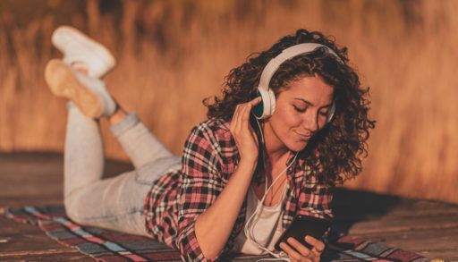 Woman listening to music on dock
