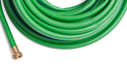 Rolled up garden new green garden hose top frame border isolated on white