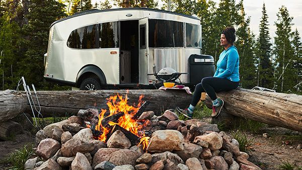 Airstream RV parked next to a campfire