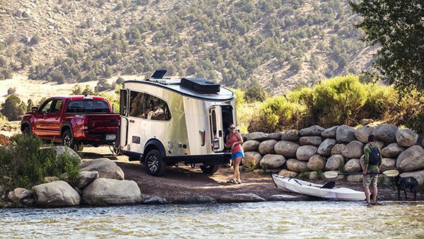 airstream basecamp RV by a river camping