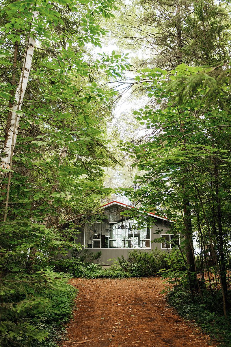 outside of Lija Skobe's cottage in the woods on balsam lake, grandparents