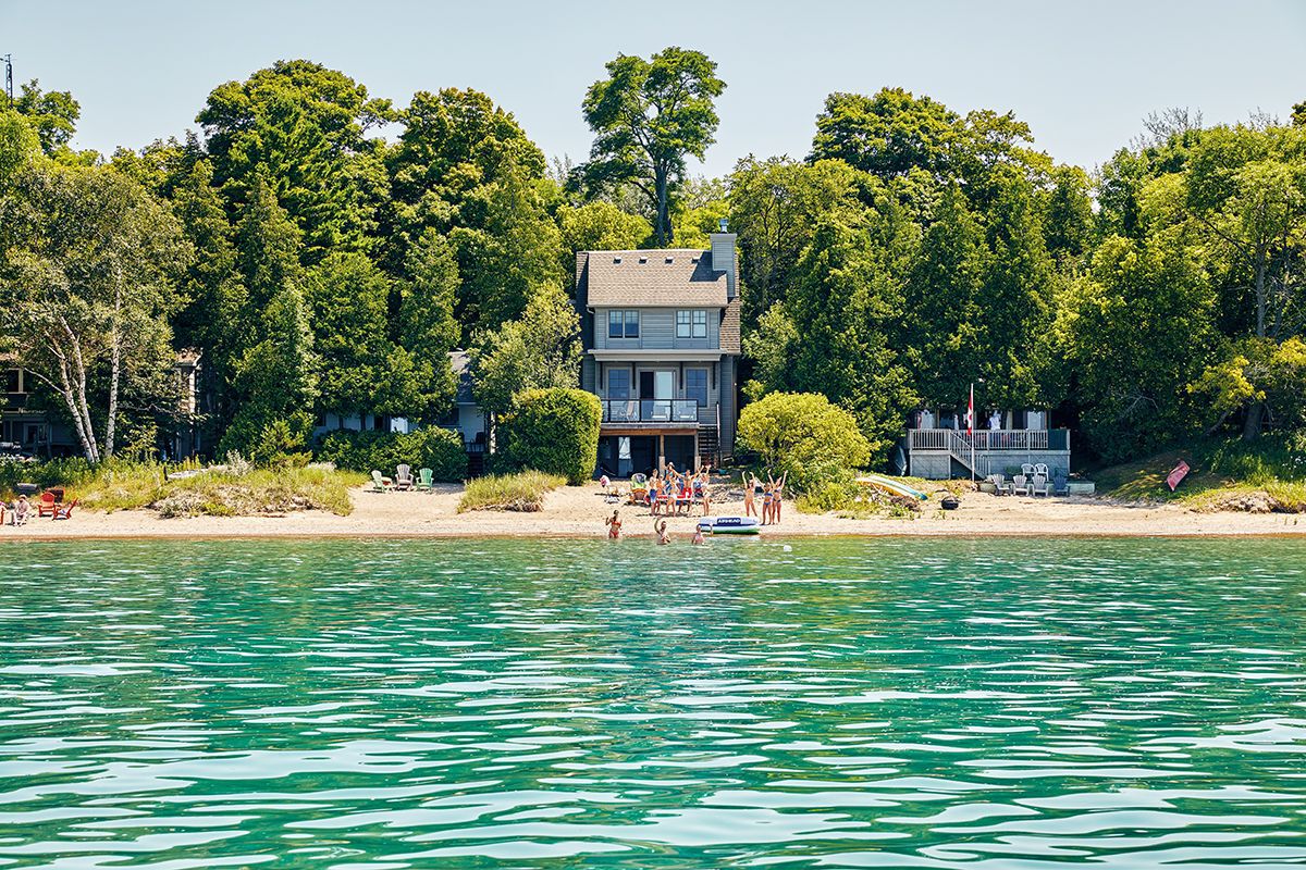 view from the water of several bruce beach cottages and kids on the beach