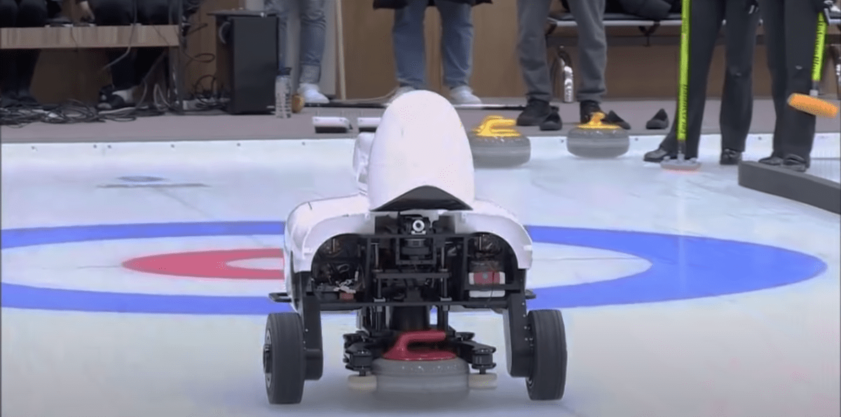 curly the AI curling robot throwing a rock down the ice