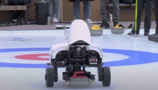 curly the AI curling robot throwing a rock down the ice