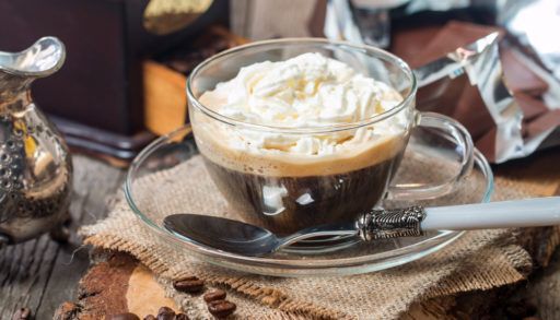 Coffee with whipped cream in glass mugs
