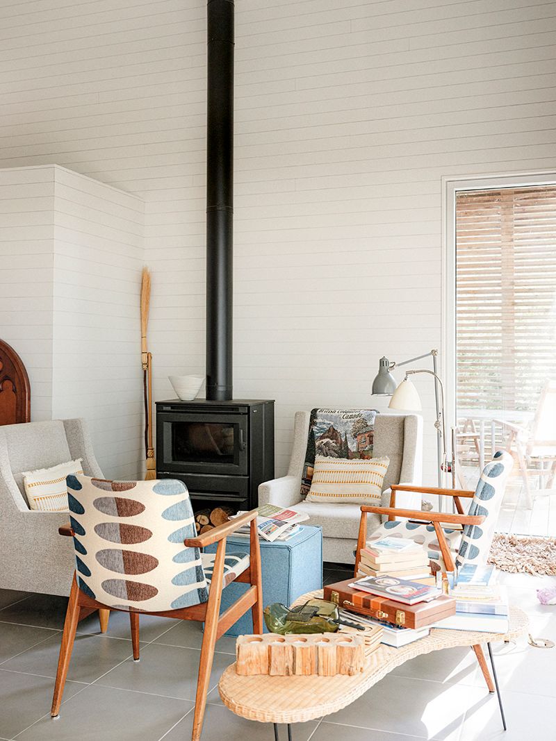 living room with w oodstove and four chairs