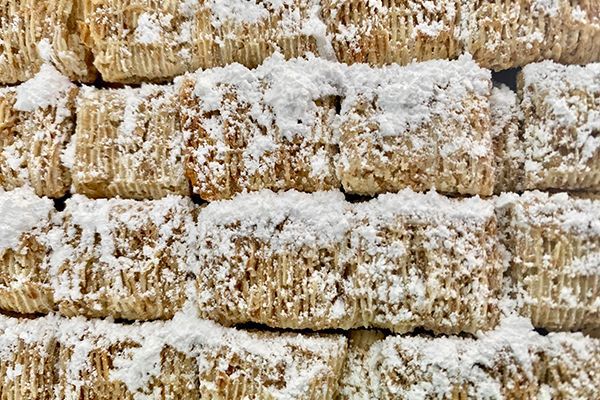 shredded wheat covered in coconut on a gingerbread cottage