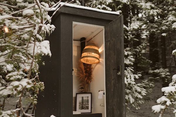 outhouse with a lantern inside